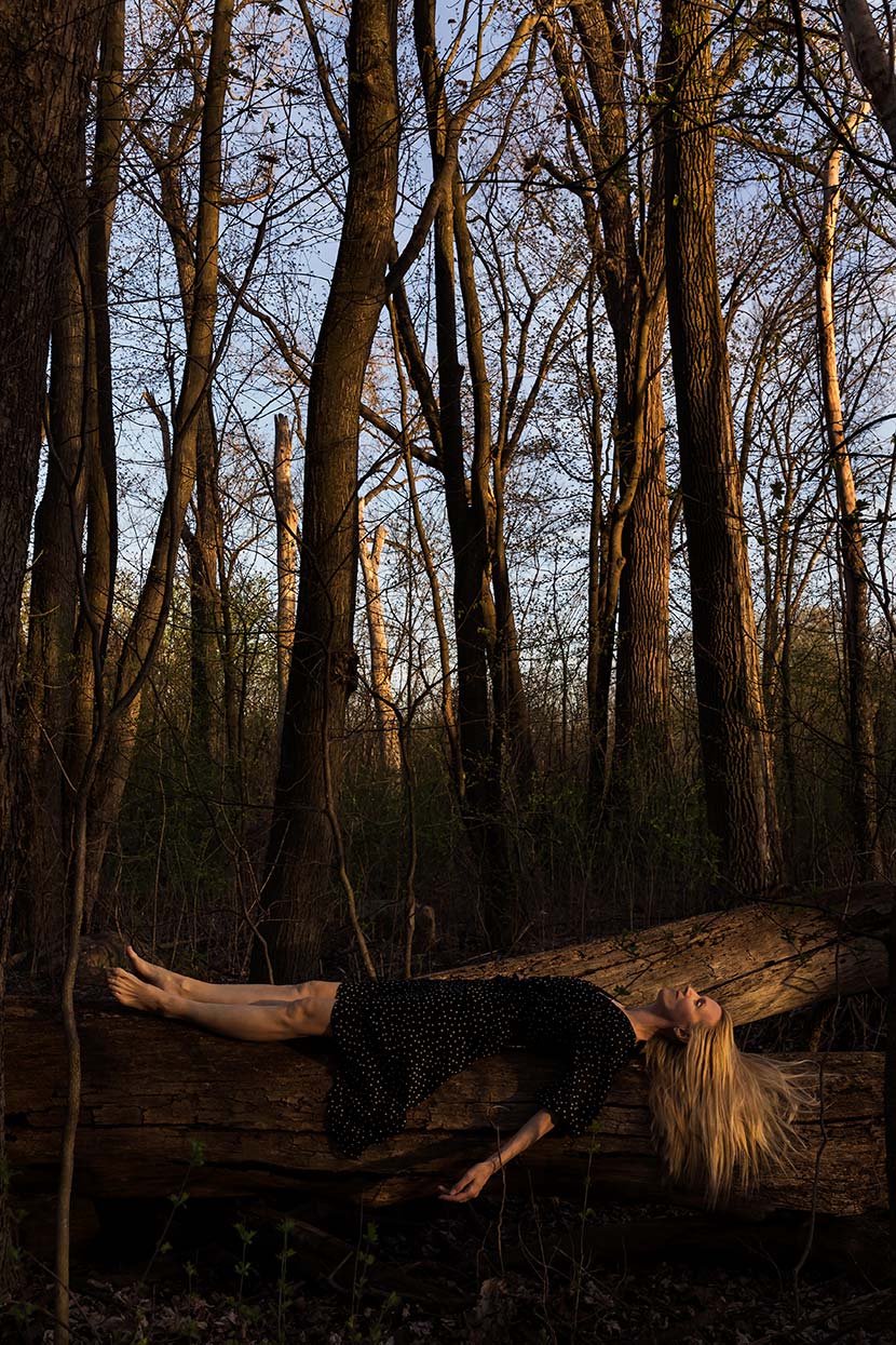 Le Repos de la Guerrière - Le Repos II - Woman lying on a fallen tree in the forest.
