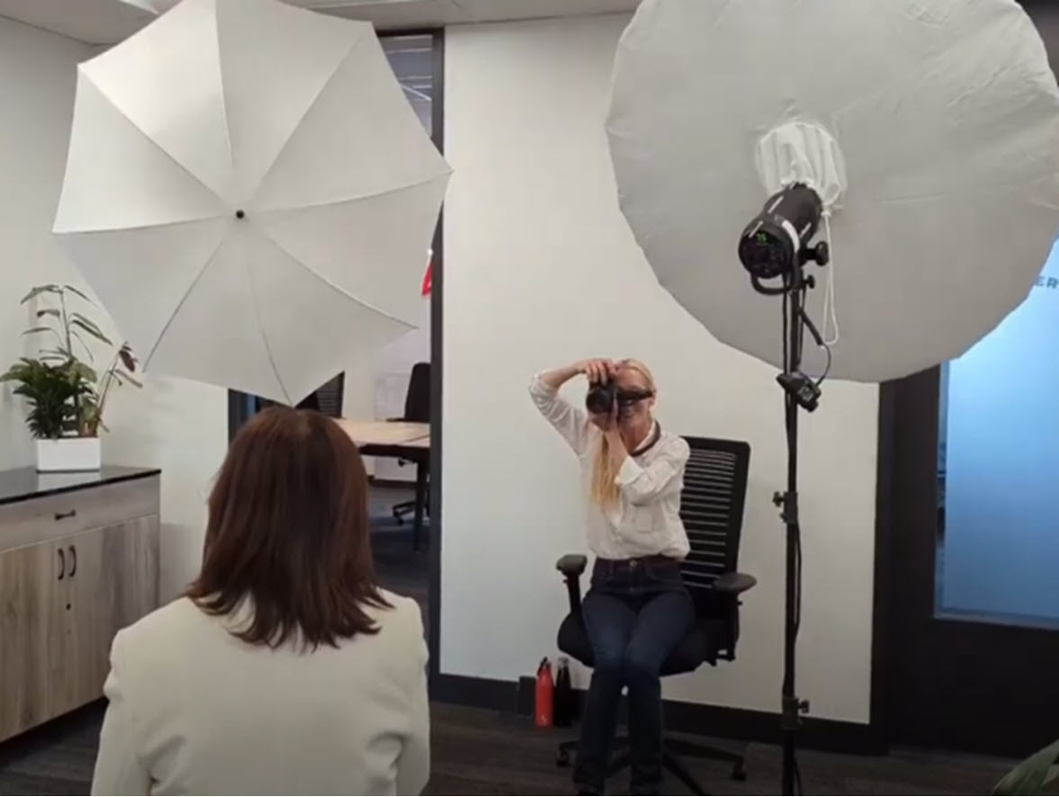 Marili taking a corporate headshot on location.